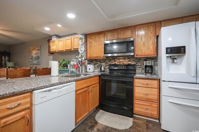 Kitchen with tasteful backsplash, recessed lightin