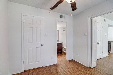 Unfurnished bedroom featuring ceiling fan, ensuite