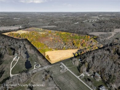 Aerial overview of property's location featuring a heavily wooded area and crop land