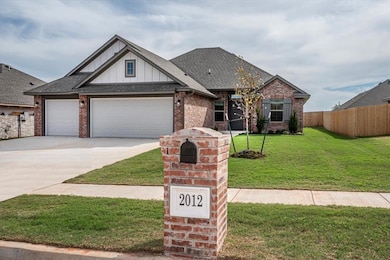 Craftsman inspired home with board and batten siding, roof with shingles, brick siding, concrete driveway, and an attached garage
