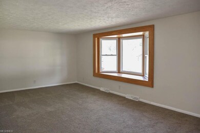 Spacious living room with a beautiful bay window.