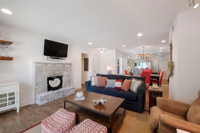 Living room with a chandelier, wood finished floo