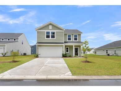 View of front of house with a garage, central AC u