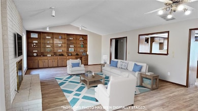 Living room with a textured ceiling, hardwood / wo