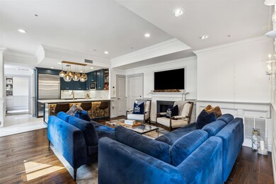 Living room with sink, crown molding, and dark har