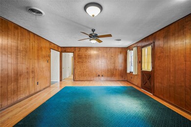 Large Family Room has hardwood floors and paneling, in very good condition