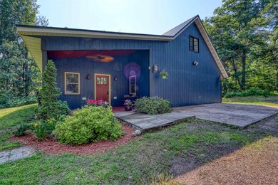 View of front of house with a metal roof and covered porch