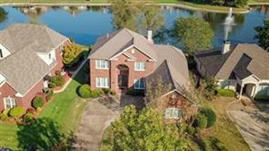 Aerial view of the home backing up to the back wit