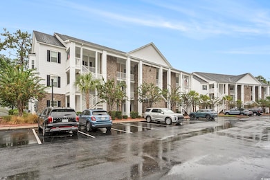 View of building exterior featuring uncovered parking