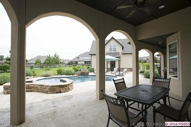 Graceful arches frame the large covered patio with
