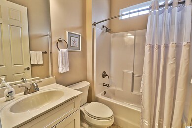 Tub/Shower combo, tile floors and white cabinetry