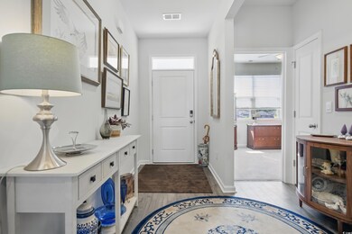 Foyer with plenty of natural light, wood finished floors, and baseboards
