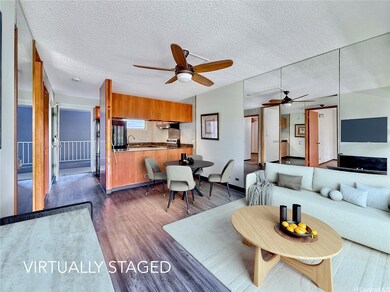 Spacious living room and open kitchen with island.