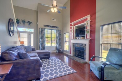 The living room has fresh paint, vaulted ceilings, a gas fireplace complemented with gorgeous stonework, beautiful hardwood floors, and tons of natural light pouring into the room.