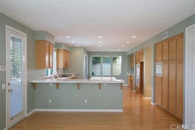 Lovely wood laminate floors brighten up this open 
