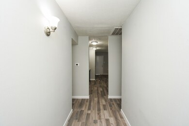 Inviting entryway leading to the spacious living a