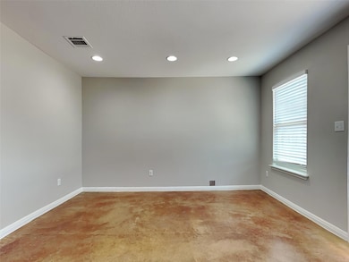 Unfurnished room with recessed lighting and baseb