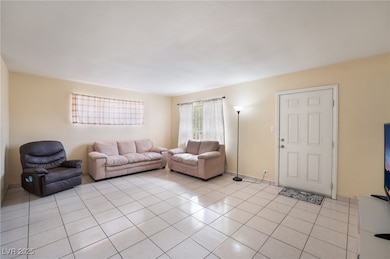Living area with light tile patterned floors