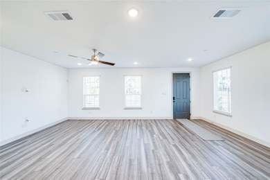 Empty room featuring light wood finished floors, recessed lighting, and ceiling fan