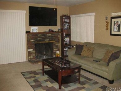 LIVING ROOM WITH FIREPLACE AND ACCESS TO BACKYARD