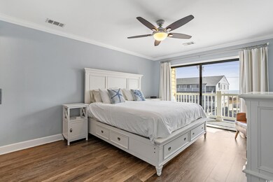 Bedroom featuring dark wood-style floors, visible 