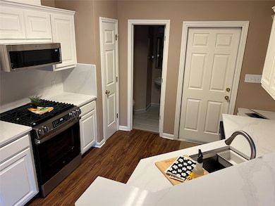 Kitchen featuring dark wood-style flooring, light