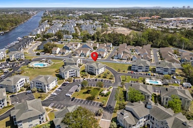 Birds eye view of property with a water view and a
