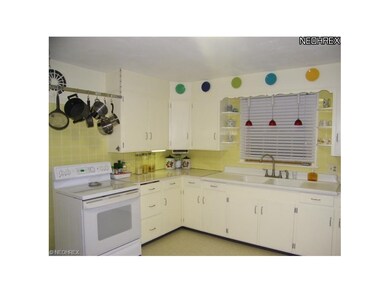 Freshly painted kitchen has new floor and updated 