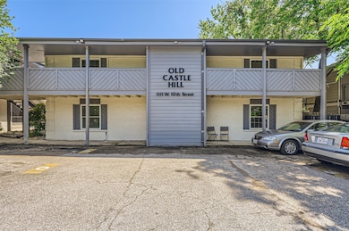 View of building exterior featuring parking