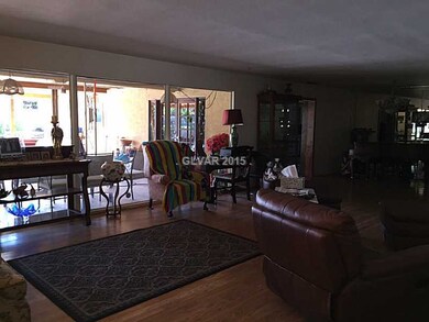 Property Photo. Tall glass windows over looking ba