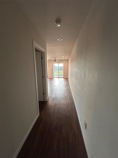 Corridor with baseboards and dark wood-type floor