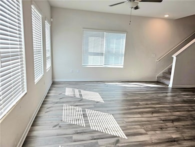 Unfurnished living room with stairway, wood finish