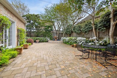 Beautiful, azalea-lined patios wrap around 3 sides of the home.