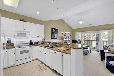 Kitchen with open floor plan, white cabinetry, a s