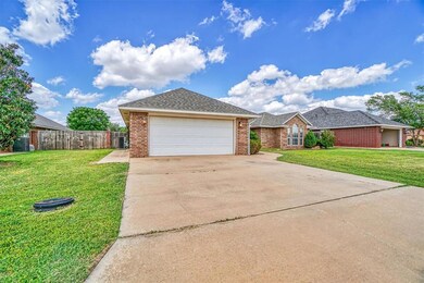 Ranch-style house with a garage and a front lawn