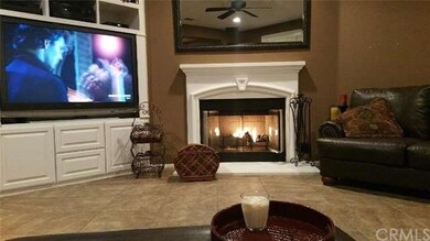 fireplace in family room with a ceiling fan and home is already wired for a sound system
