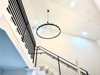 North stairway with modern black railing and lighting fixture