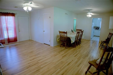 Dining room featuring ceiling fan and laminate flo