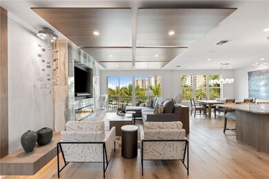 Living room featuring light wood finished floors, plenty of natural light, recessed lighting, and a chandelier