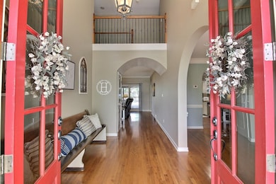 Foyer featuring baseboards, a high ceiling, crown 