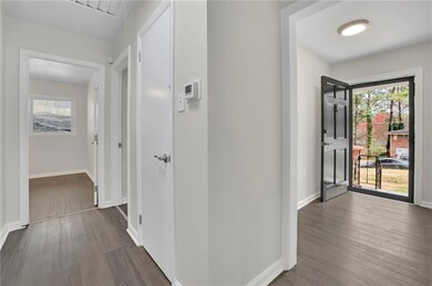 Corridor with baseboards, wood finished floors, an