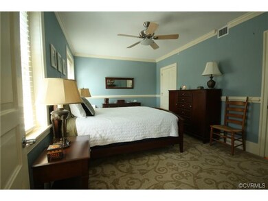 Large master bedroom with hardwood floor and moldi