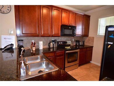 Kitchen - Includes stainless steel double sink, dishwasher, double door refrigerator with ice amker, new stainless steel range, built in microwave, granite tops and maple wood cabinets with dark cherry finish.