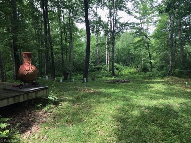 Deck overlooks mature trees and gently rolling lan