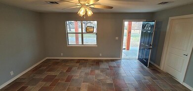 Unfurnished room featuring a wealth of natural lig