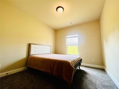 Bedroom featuring baseboards and carpet floors