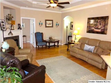 The living room has hardwood floors and plenty of 