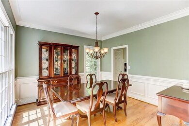 Formal Dining Room with Wainscot Molding and Wood 