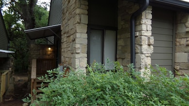 View of exterior entry with stone siding