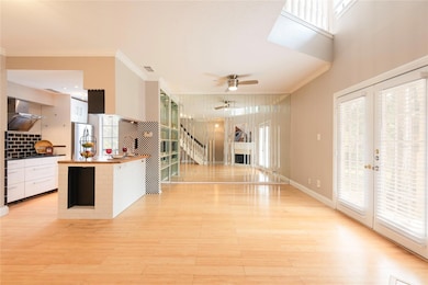Kitchen featuring white cabinets, crown molding, w